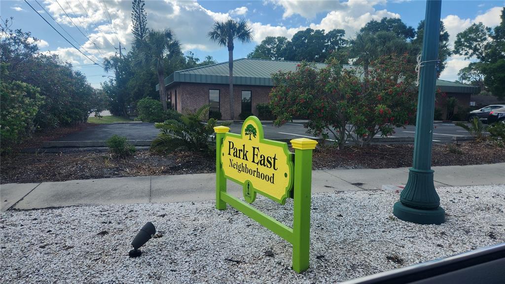 A yellow and green sign for Park East Neighborhood stands in front of a brick building — 2117 5TH STREET UNIT Front House, SARASOTA, FL