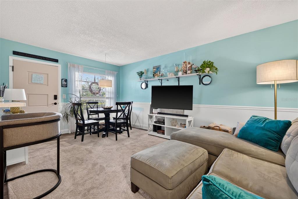 A kitchen pass-through window with a countertop overlooks a hallway with light blue walls — 4000 3RD STREET N UNIT 304, ST PETERSBURG, FL