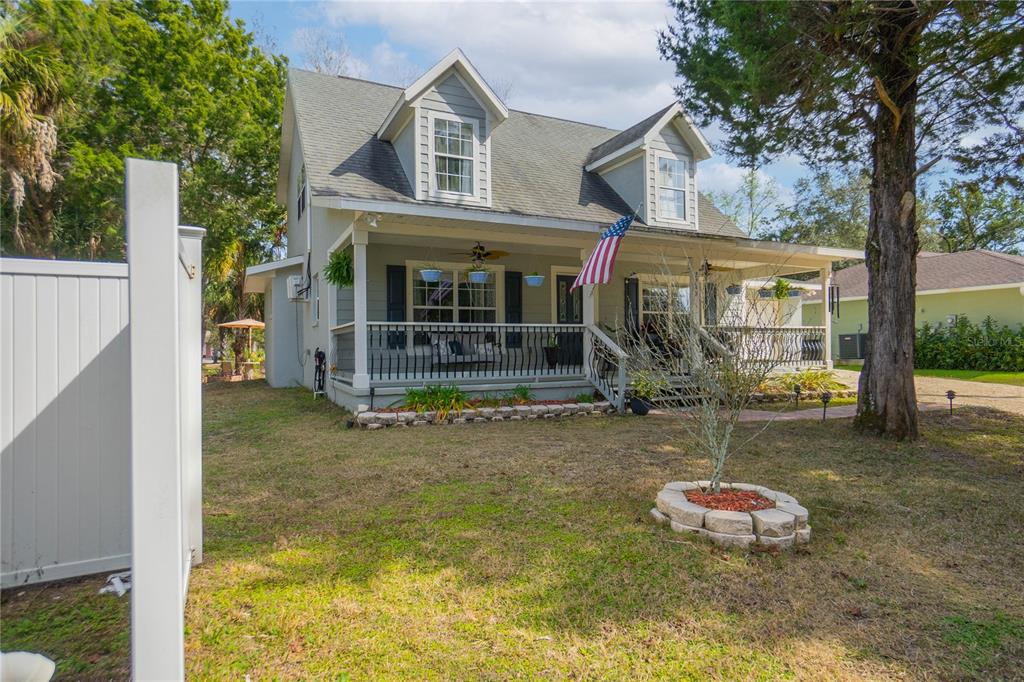 A two-story house with a front porch, dormer windows, and a grassy yard — 2283 S TODD POINT, HOMOSASSA, FL