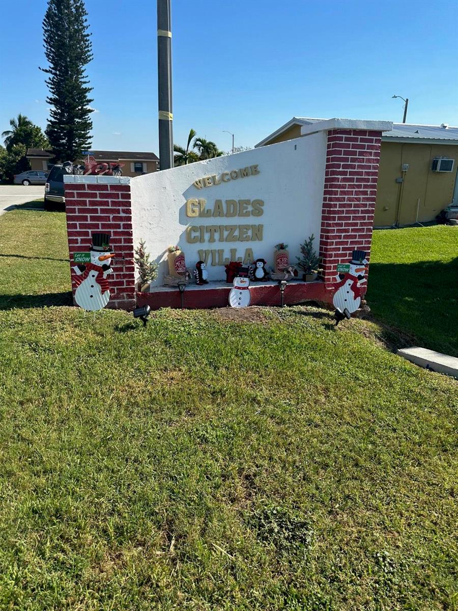 A brick and stucco monument sign welcomes visitors to Glades Citizen Villa — 501 W Baines Terrace, Pahokee FL 33476, PAHOKEE, FL