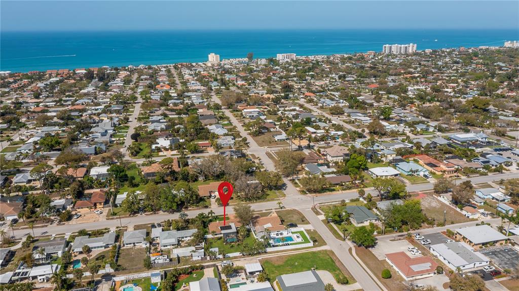 An aerial view shows a residential neighborhood with a red location pin over a house — 809 NOKOMIS AVENUE S, VENICE, FL