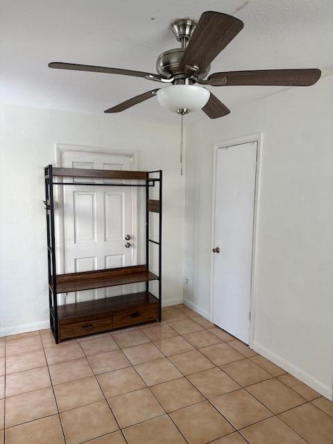 A room with a ceiling fan, a metal and wood storage unit, and tiled flooring — 807 Phippen Waiters Road # 2, Dania Beach FL 33004, DANIA BEACH, FL