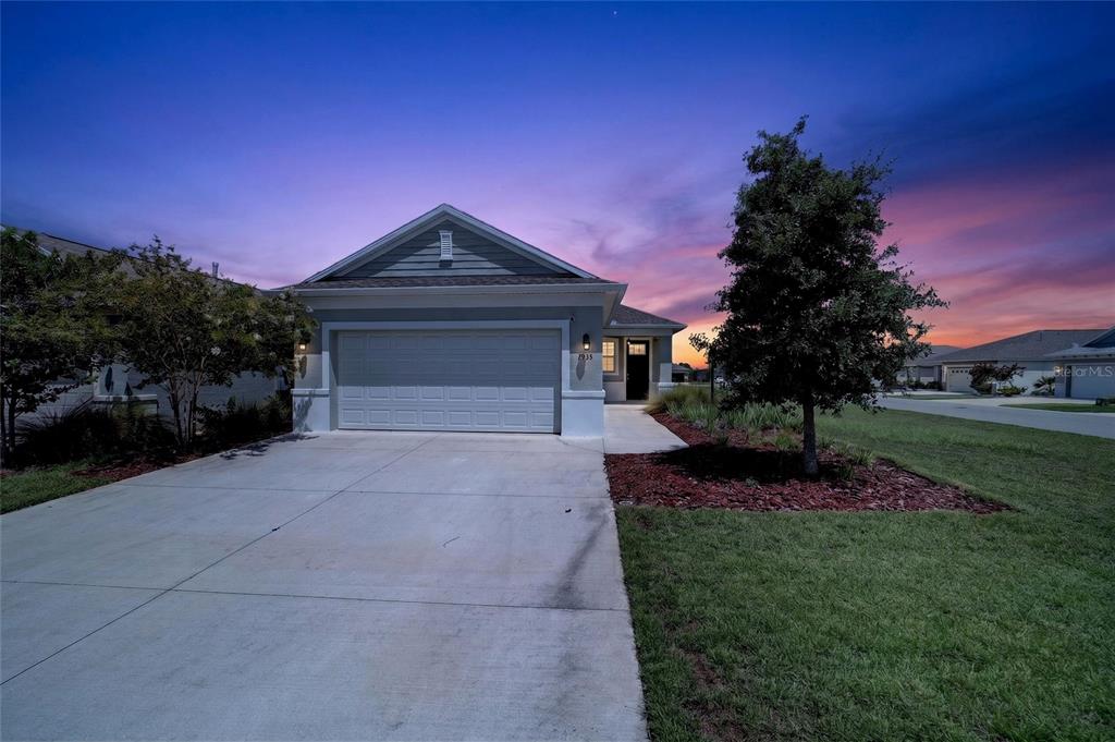 A single-story house with a two-car garage, concrete driveway, and front yard landscaping — 7935 SW 89TH TERRACE, OCALA, FL