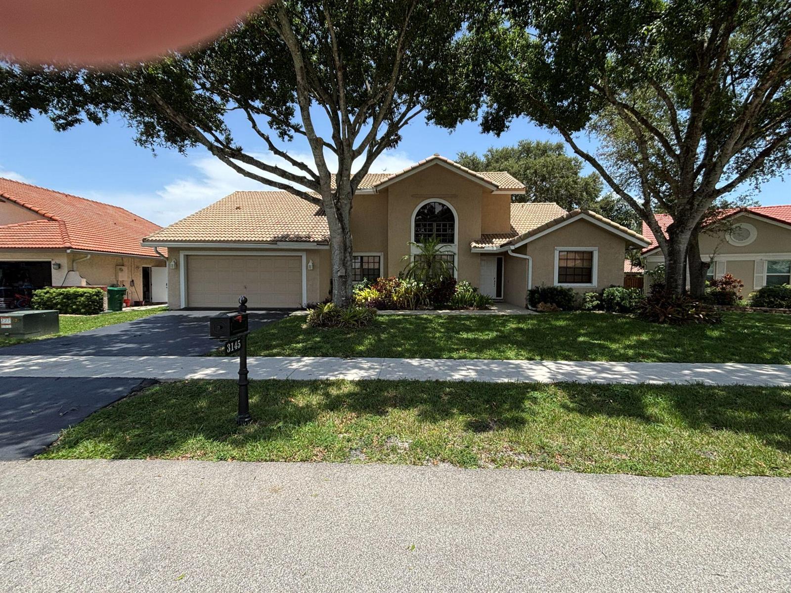 A brick entrance sign for Forest Ridge sits behind a bed of colorful foliage — 3145 Peachtree Way, Davie FL 33328, DAVIE, FL