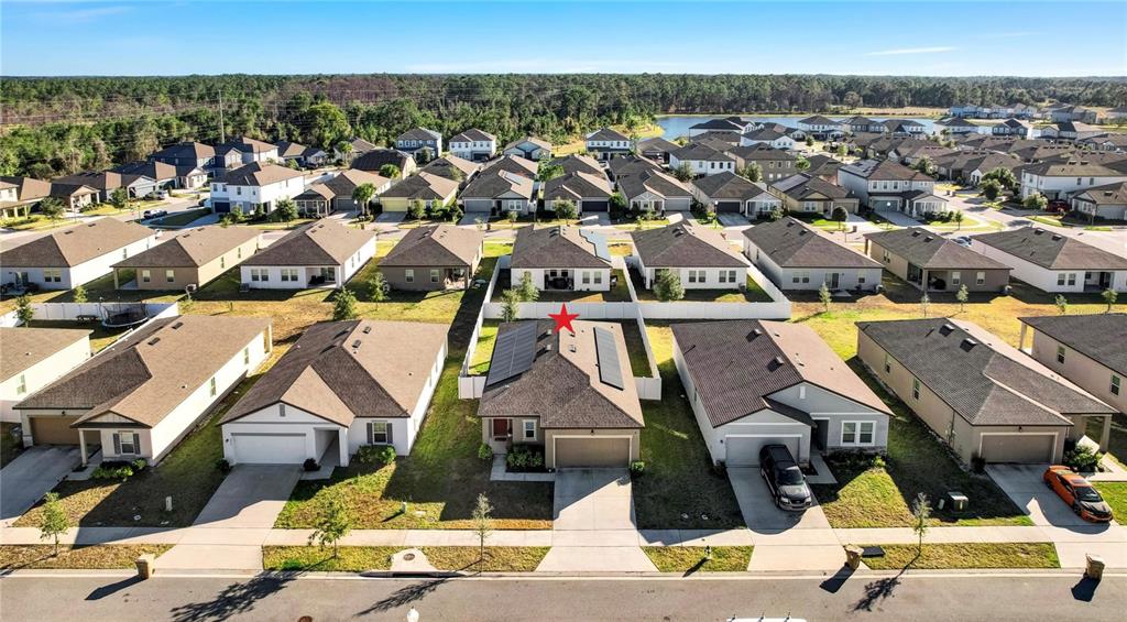 An aerial view shows a suburban neighborhood with a red star marking a specific house — 5860 BOVINE DRIVE, ST CLOUD, FL