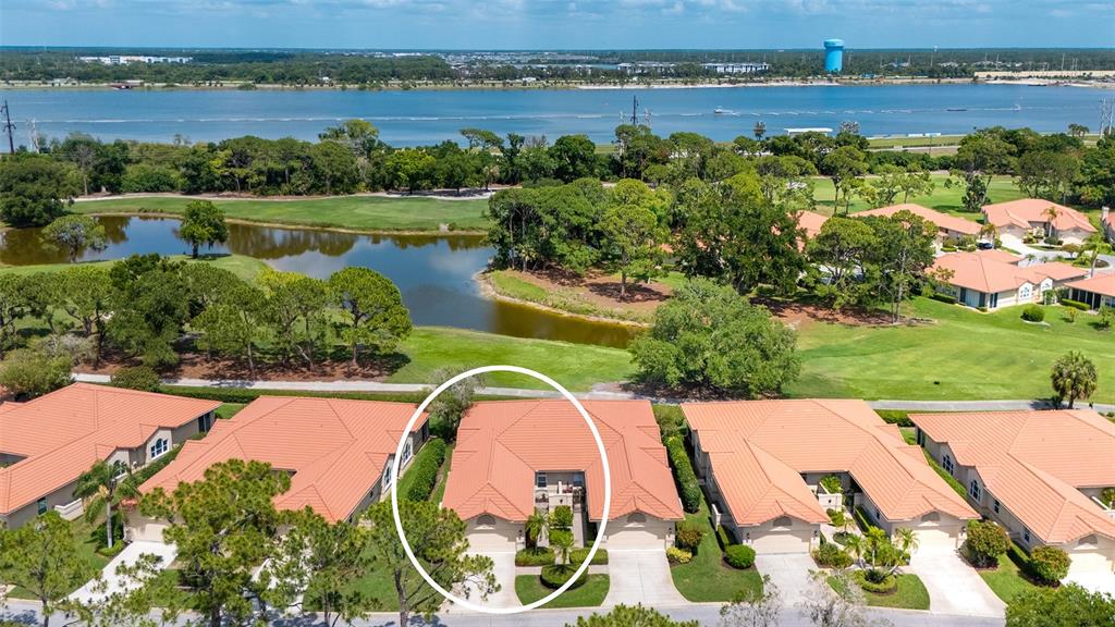 An aerial view shows a residential villa with a tiled roof and a private courtyard — 3374 W CHELMSFORD COURT UNIT 9, SARASOTA, FL