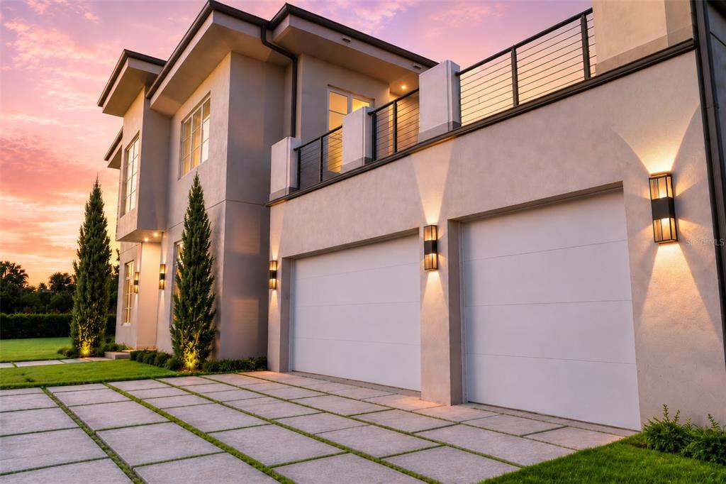 A modern two-story house exterior features a two-car garage, concrete driveway, and upper-level balcony — 1351 VIA MARKHAM COURT, LAKE MARY, FL