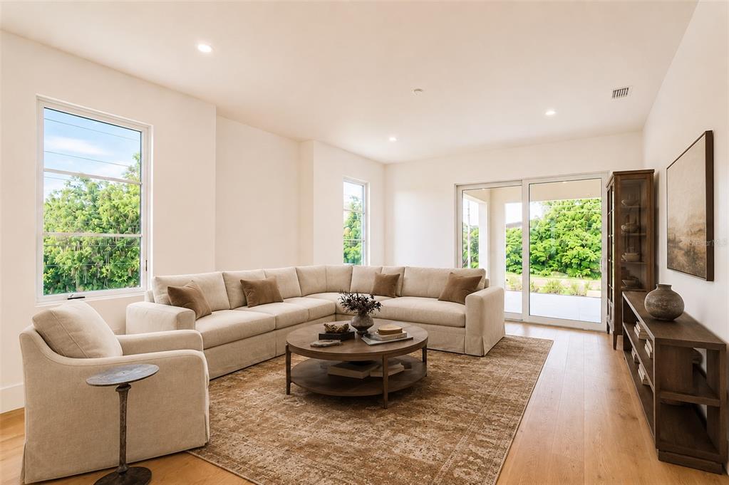 A living room features a beige sectional sofa, a round wooden coffee table, and sliding doors — 1351 VIA MARKHAM COURT, LAKE MARY, FL