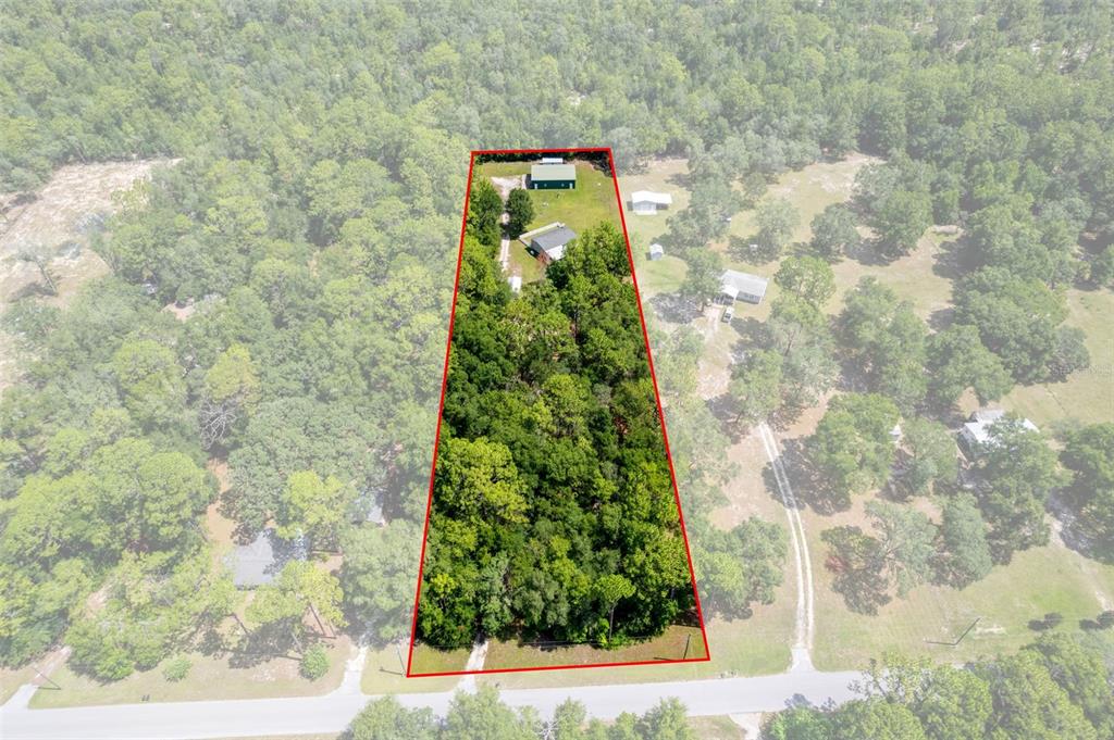 An aerial view shows a trapezoidal lot containing a house and a detached garage — 18303 SW 27TH STREET, DUNNELLON, FL