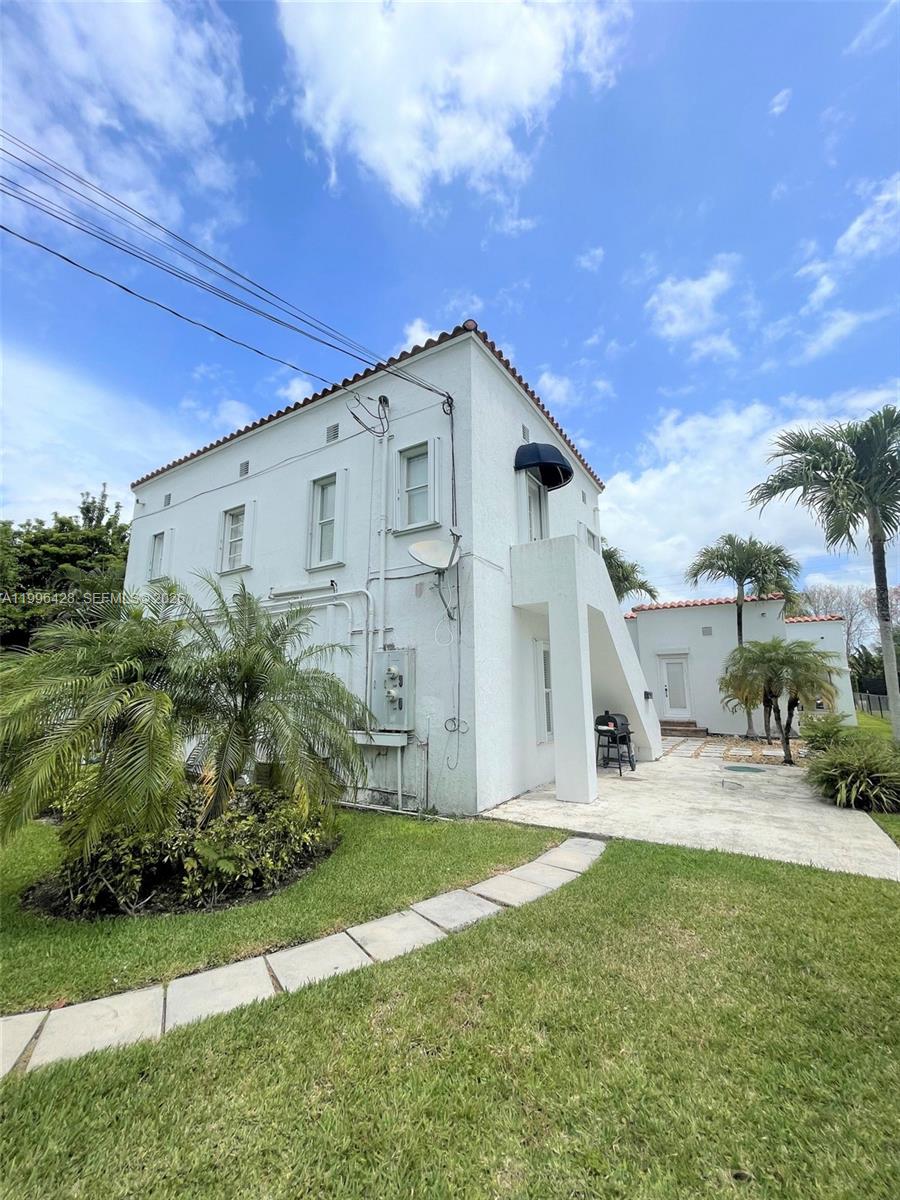 A two-story white stucco building with a patio and palm trees in the yard — 5116 SW 57th Ave # A, Miami FL 33155, MIAMI, FL