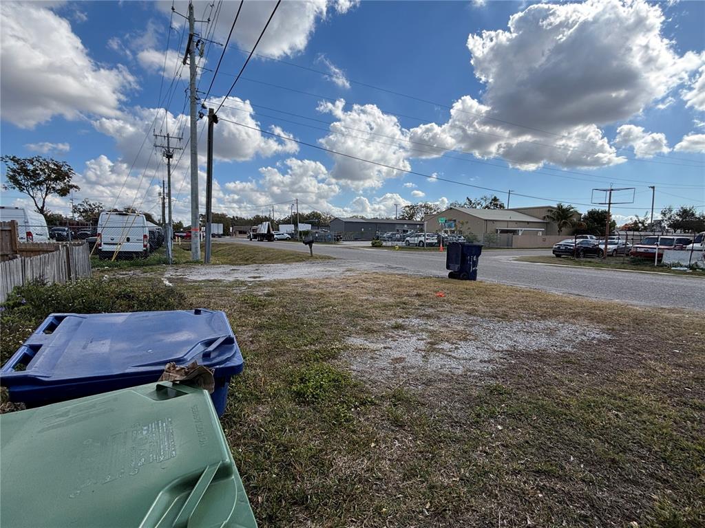 A gravel lot with two trash bins in the foreground and a street in the background — 4213 W CAYUGA STREET, TAMPA, FL