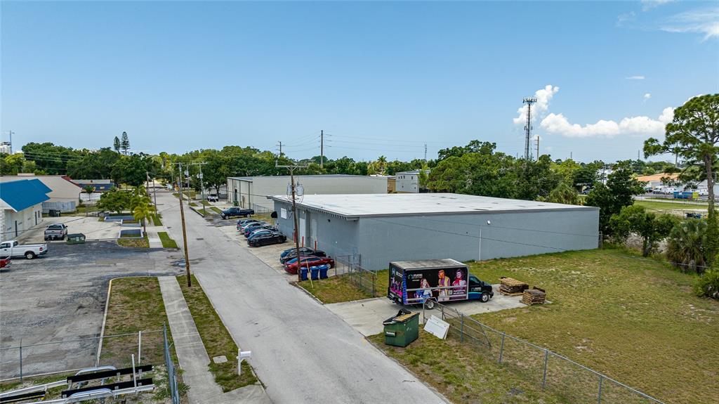 An aerial view shows a commercial building with a parking lot and a delivery truck — 2169 10TH STREET, SARASOTA, FL