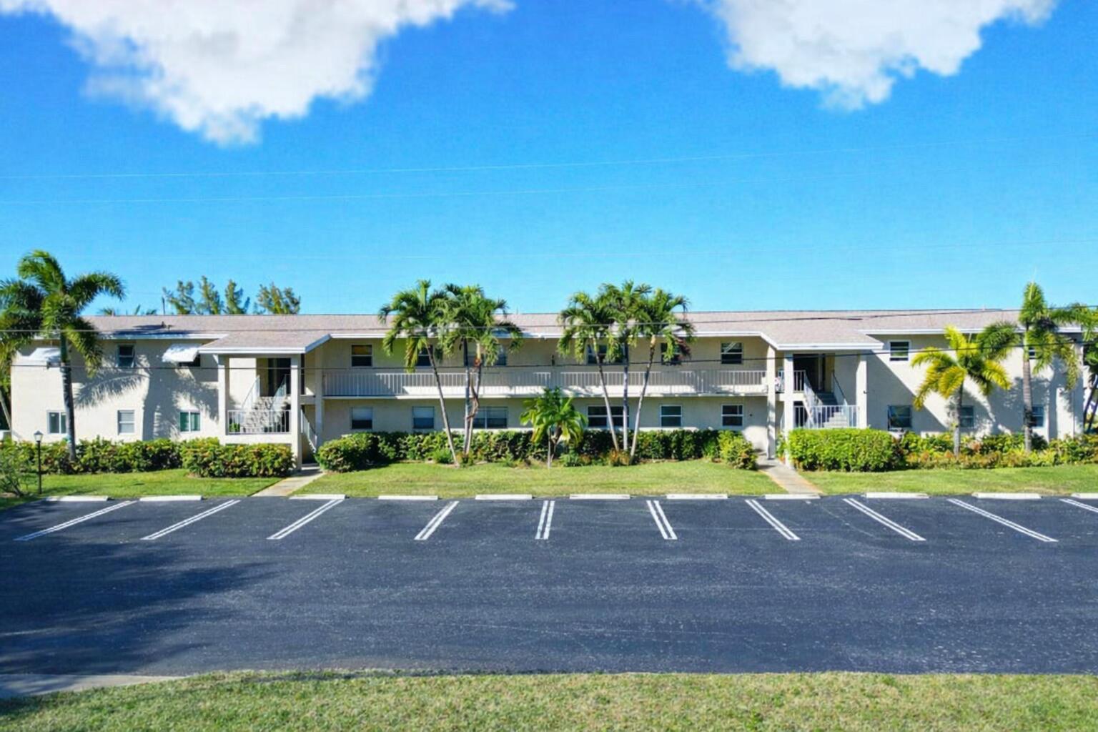 A two-story apartment building with a parking lot in front and palm trees — 301 Circle Drive S # 103, Boynton Beach FL 33435, BOYNTON BEACH, FL
