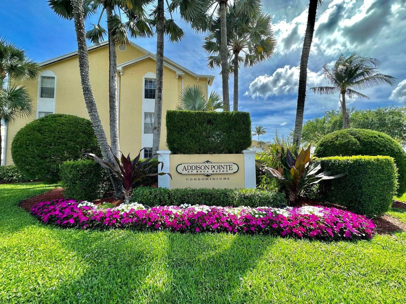 A yellow apartment building stands behind a landscaped sign for Addison Pointe at Boca Raton — 6315 La Costa Drive # A, Boca Raton FL 33433, BOCA RATON, FL