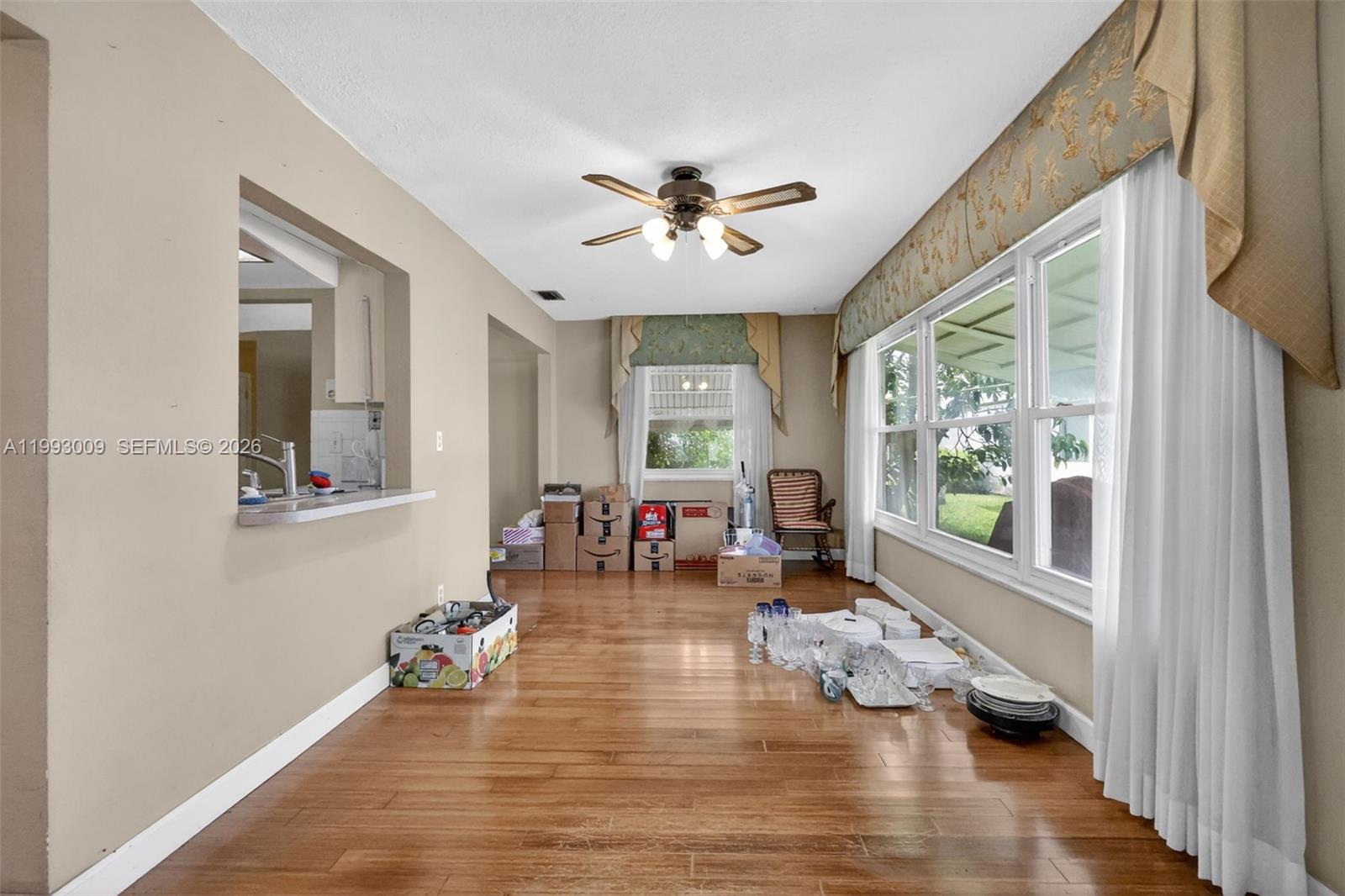 This room features hardwood floors, a ceiling fan, and large windows with fabric valances — 1104 Ocean Ave, Boynton Beach FL 33426, BOYNTON BEACH, FL