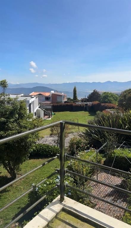 A view from a balcony overlooking a grassy yard, neighboring houses, and distant mountains — 16 VEREDA YERBABUENA, VILLAS DE YERBABUENA, FL
