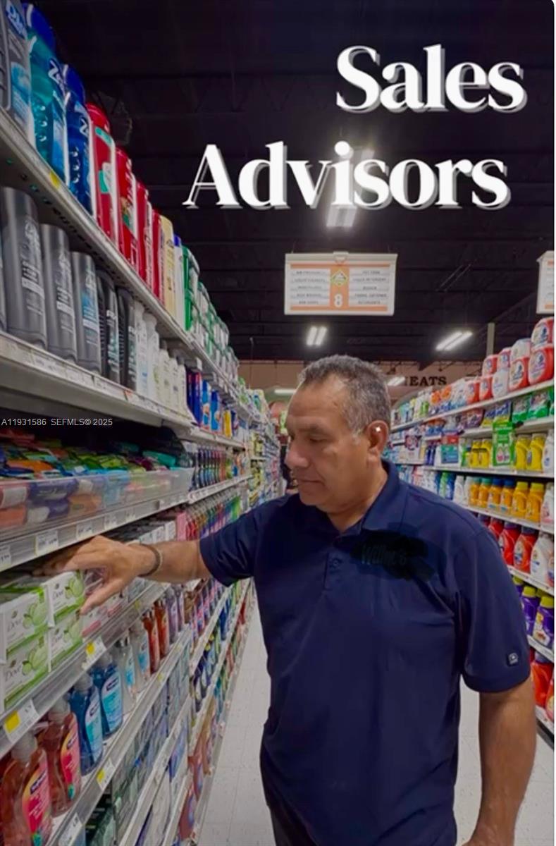 A man in a blue polo shirt stands in a grocery store aisle — 79th, Miami FL 33166, MIAMI, FL