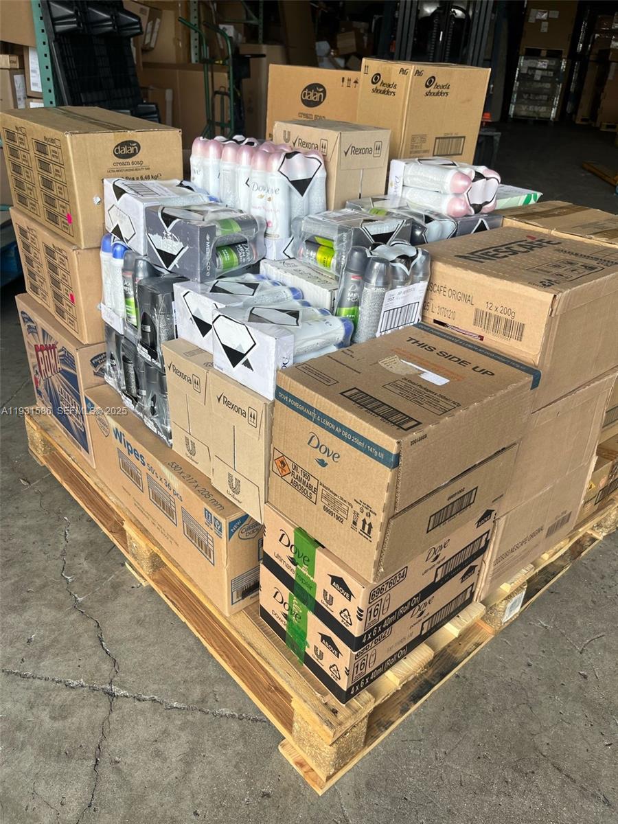A wooden pallet loaded with various cardboard boxes of consumer goods sits on a concrete floor — 79th, Miami FL 33166, MIAMI, FL