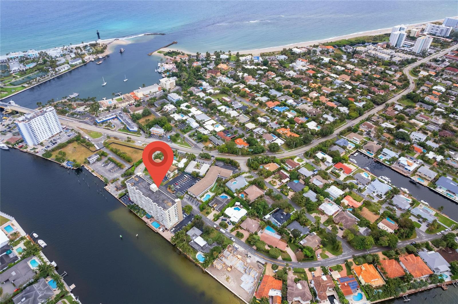 An aerial view shows a multi-story apartment building with a red location pin on it — 2611 N Riverside Drive # 307, Pompano Beach FL 33062, POMPANO BEACH, FL