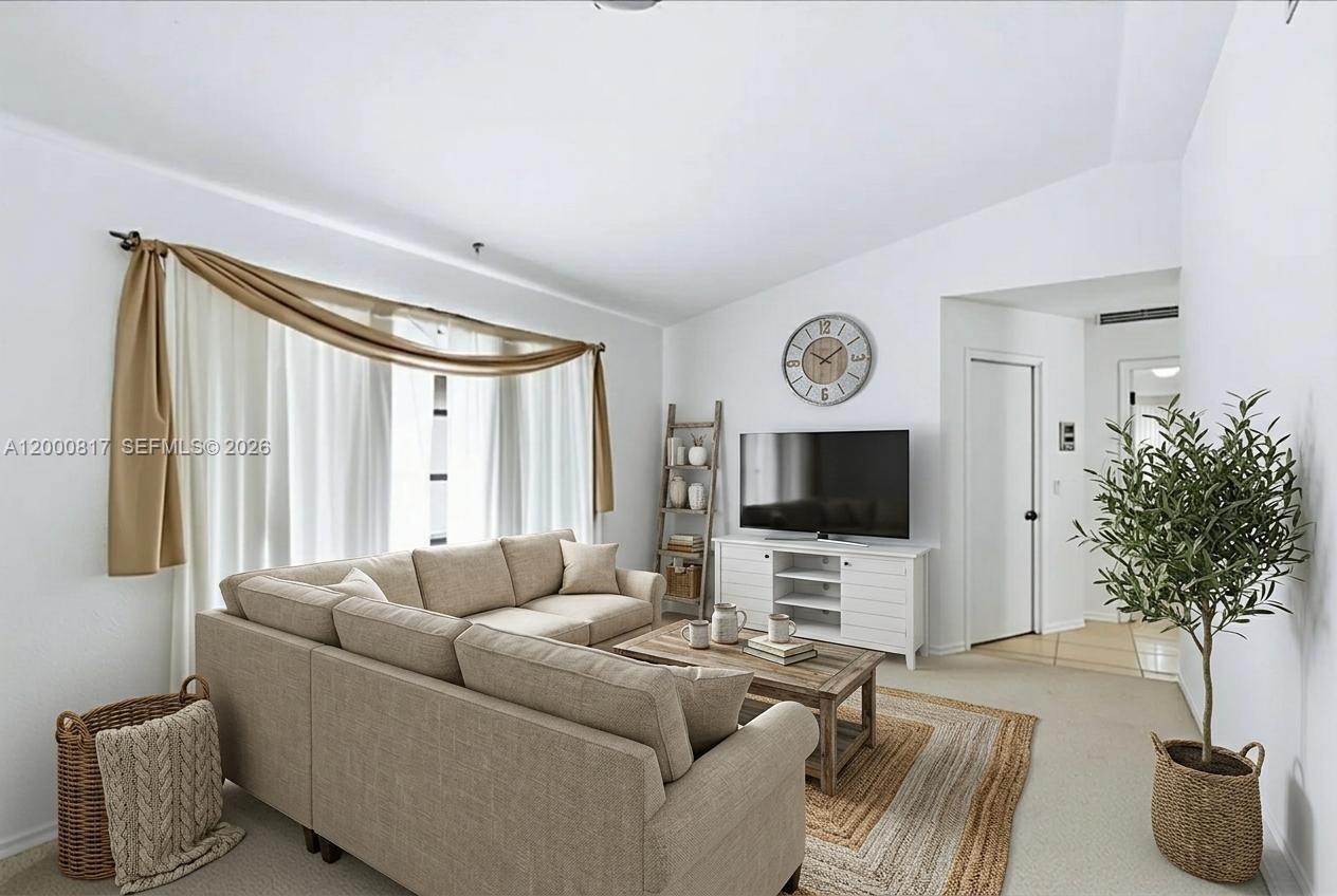 A living room features a beige sectional sofa, a television on a white stand, and curtains — PORT CHARLOTTE, FL