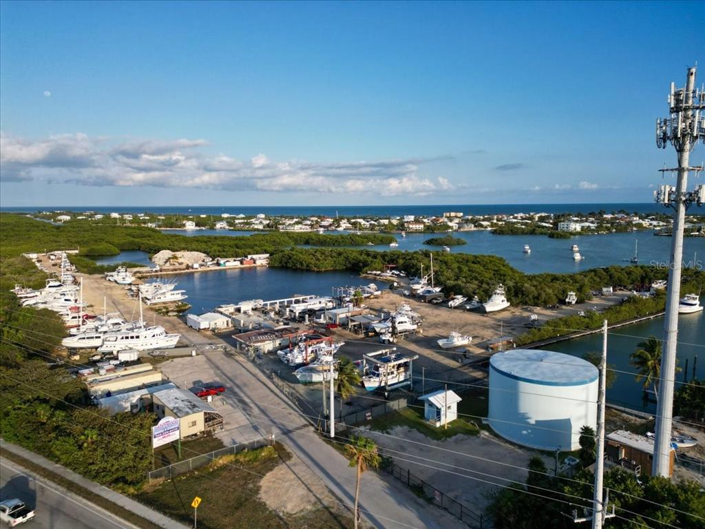 An aerial view of a marina with numerous boats docked in a coastal setting — 13900 OVERSEAS HWY, MARATHON, FL
