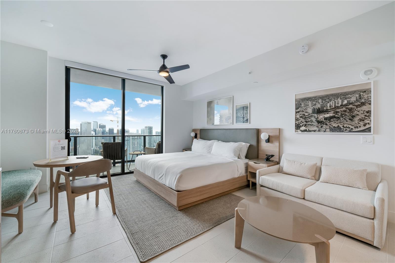 A modern bedroom features a king bed, a sofa, a dining set, and a balcony view — 601 NE 1st Ave # 4212, Miami FL 33132, MIAMI, FL