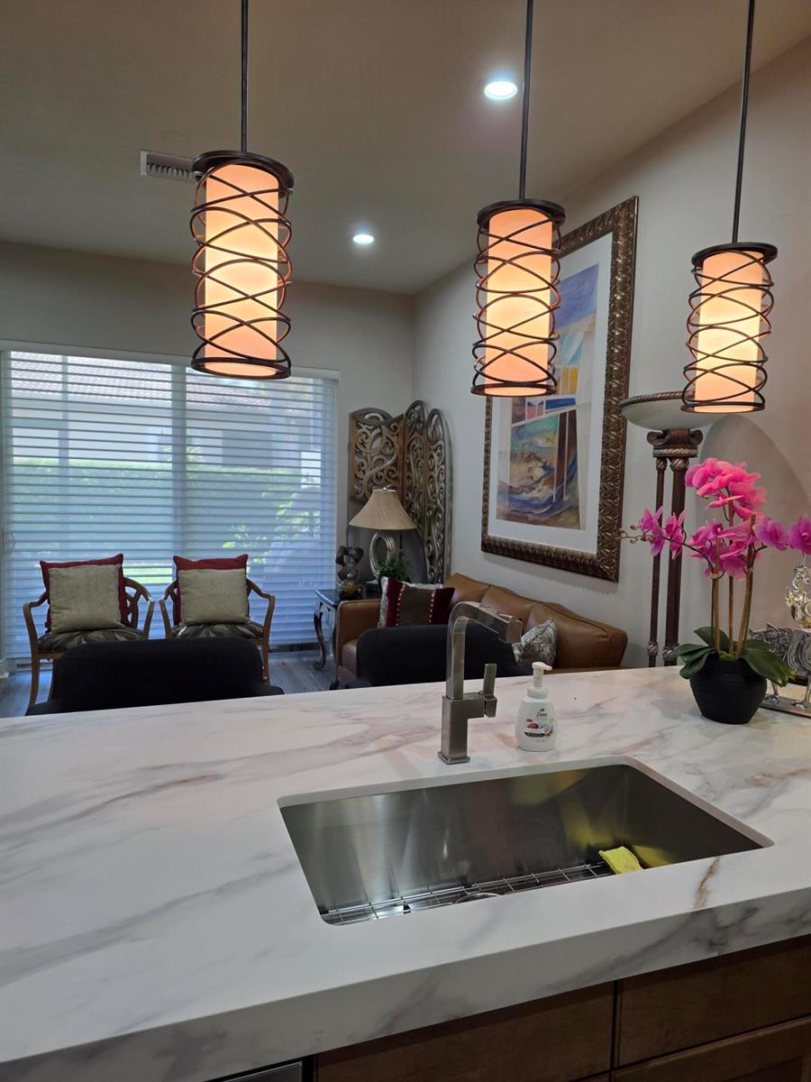 A single-story house exterior features a brown garage door, a paved driveway, and landscaping — 14748 Barletta Way, Delray Beach FL 33446, DELRAY BEACH, FL