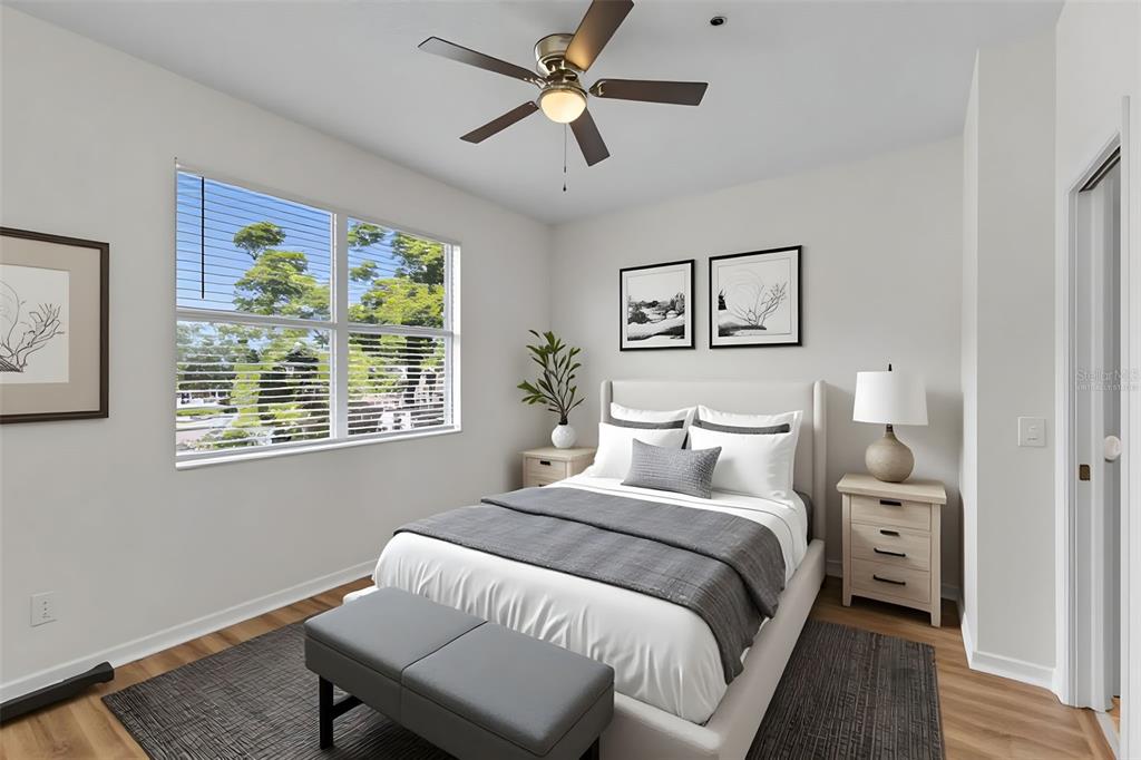 A bedroom features a bed, a ceiling fan, a window, and two nightstands — 3851 VIRGA BOULEVARD, SARASOTA, FL