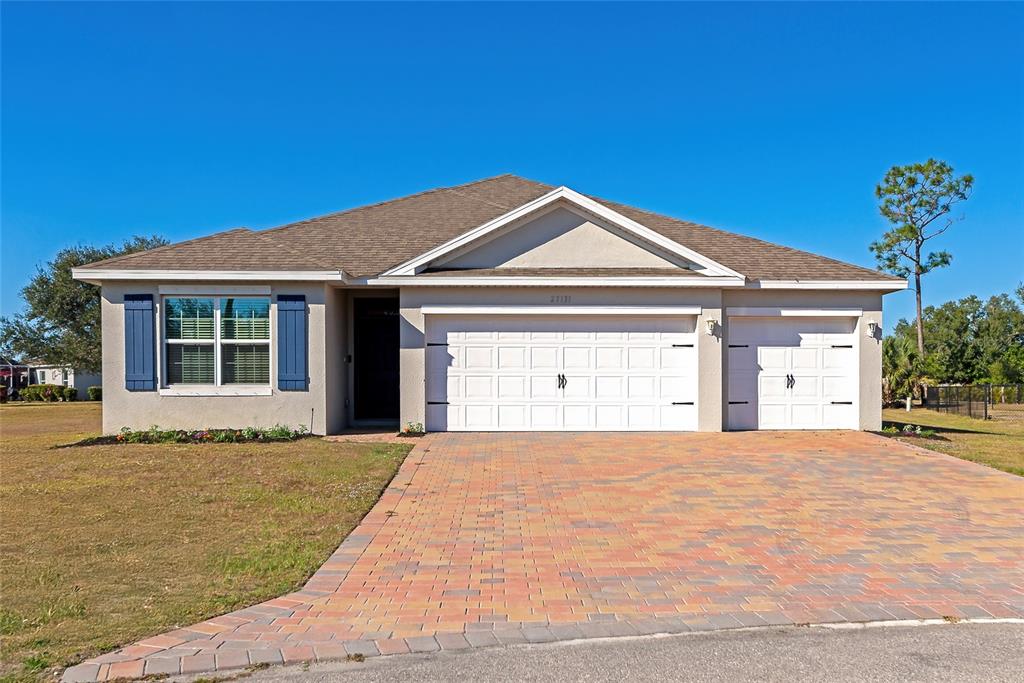 A bright entryway features light wood-look tile flooring, white walls, and a white front door — 27131 GUAPORE DRIVE, PUNTA GORDA, FL