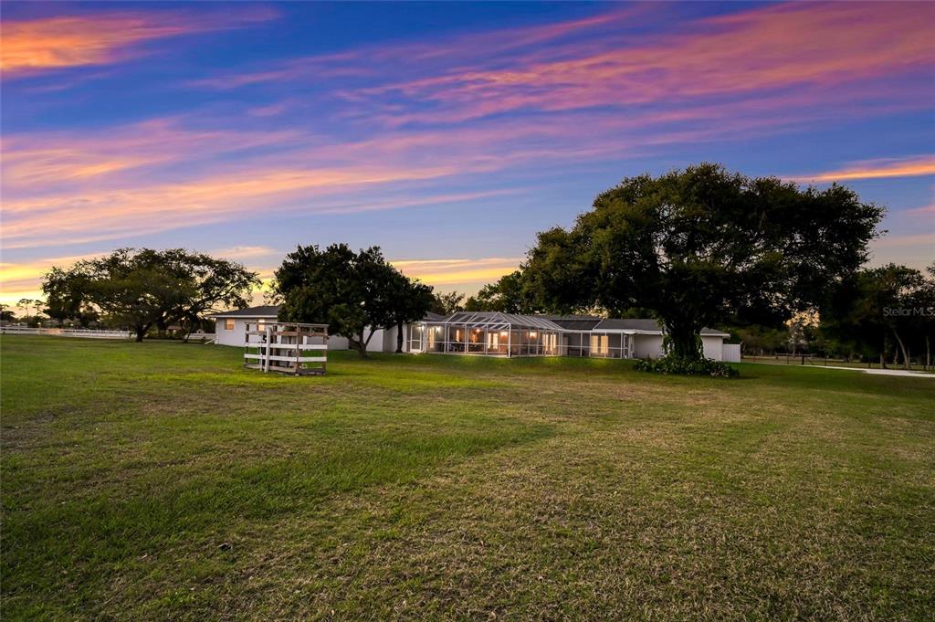 A two-story house with a garage and a parked recreational vehicle on a grassy lot — 1516 FOX CREEK DRIVE, SARASOTA, FL
