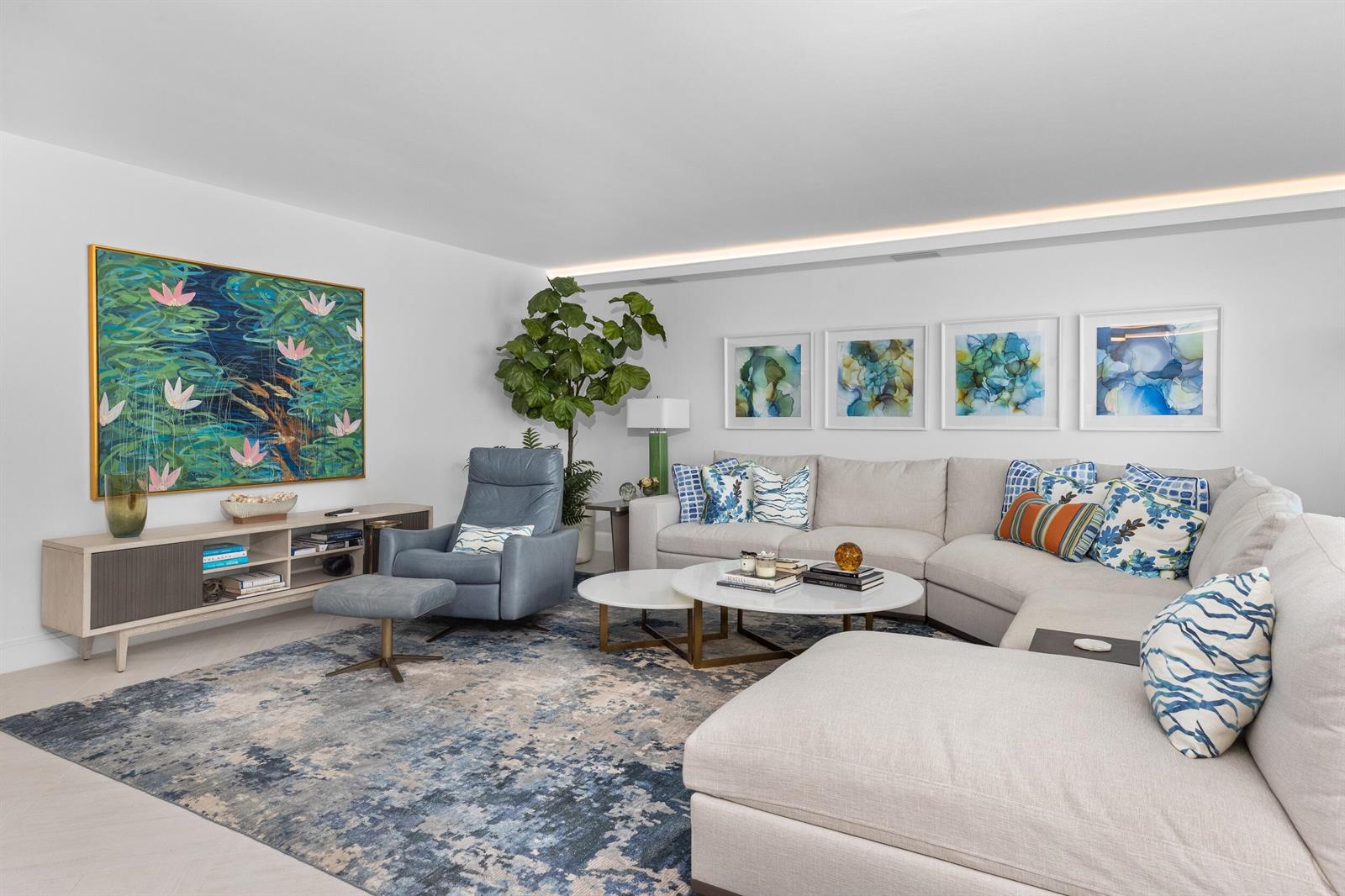 A living room features a large sectional sofa, blue armchair, area rug, and wall art — 1500 S Ocean Boulevard # 1505, Boca Raton FL 33432, BOCA RATON, FL