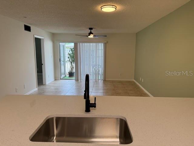 The exterior of a multi-story apartment building features light green siding, balconies, and landscaped bushes — 6826 STONES THROW CIRCLE N UNIT 11101, ST PETERSBURG, FL