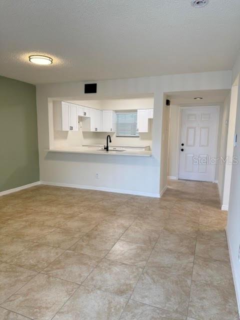 An exterior view of a covered entryway with light green siding and two white doors — 6826 STONES THROW CIRCLE N UNIT 11101, ST PETERSBURG, FL