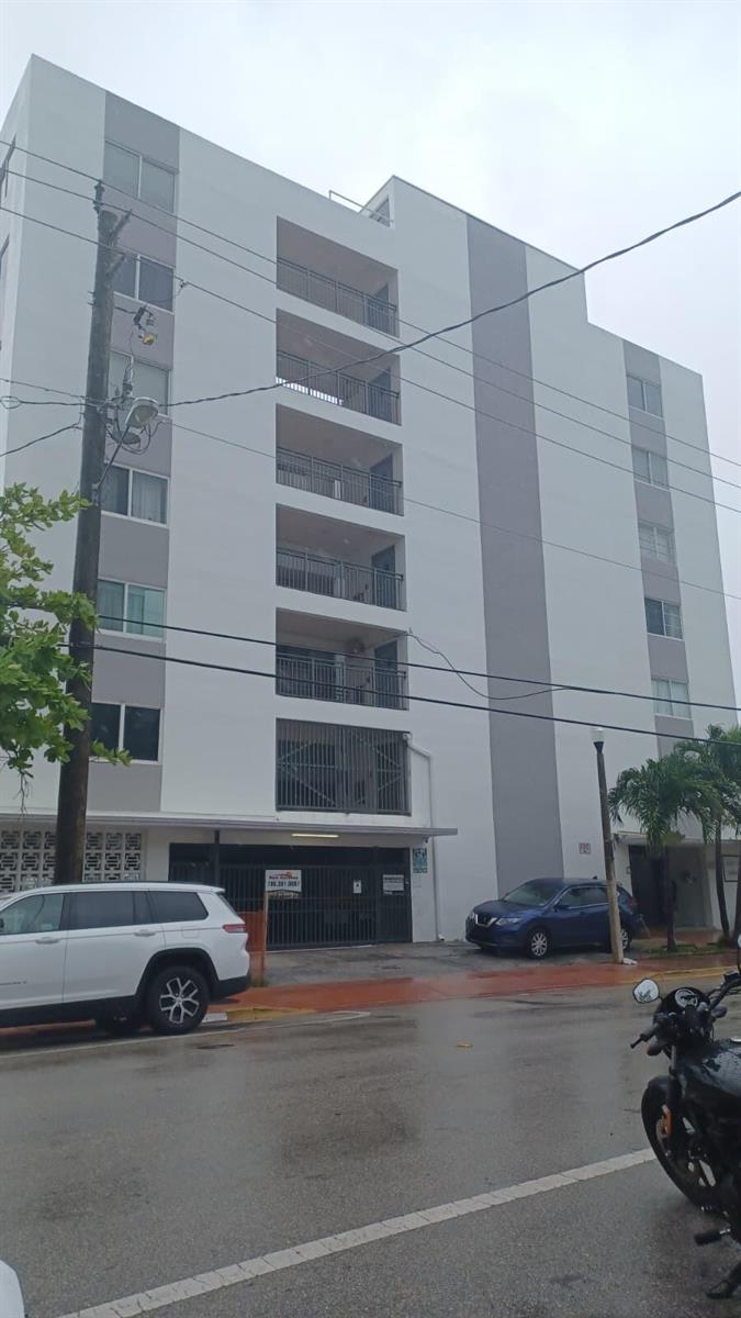 A multi-story apartment building with a gated ground-level parking garage and balconies — 8001 N Crespi Boulevard # 2c, Miami Beach FL 33141, MIAMI BEACH, FL