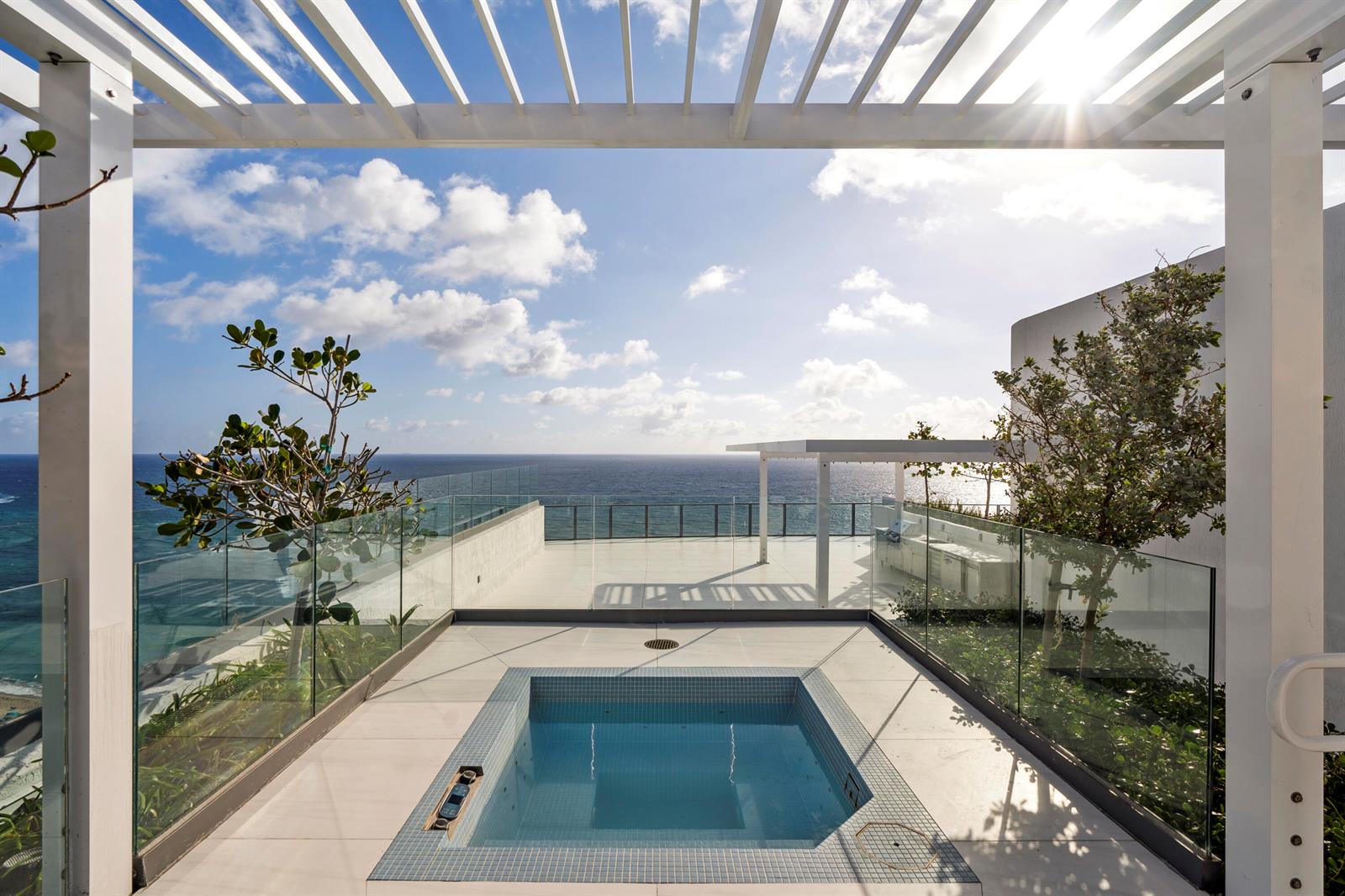 A rooftop terrace features a square tiled hot tub, glass railings, and ocean views — 1116 N Ocean Boulevard, Pompano Beach FL 33062, POMPANO BEACH, FL