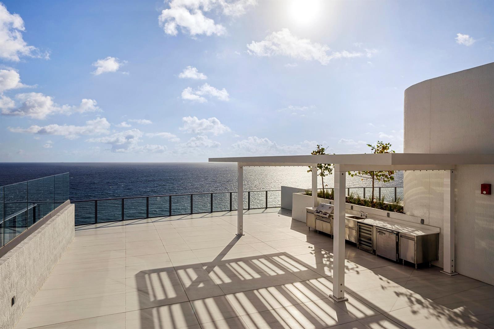 A rooftop terrace features a stainless steel outdoor kitchen, a pergola, and ocean views — 1116 N Ocean Boulevard, Pompano Beach FL 33062, POMPANO BEACH, FL