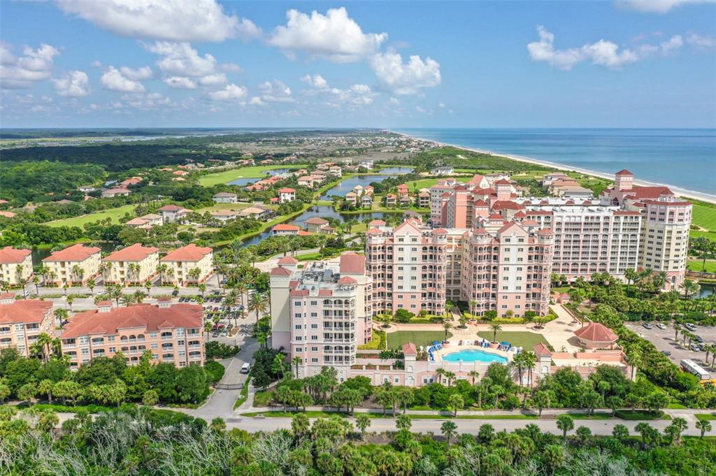 An aerial view of a large resort complex with multiple buildings, a pool, and oceanfront access — 200 OCEAN CREST DRIVE UNIT 924, PALM COAST, FL