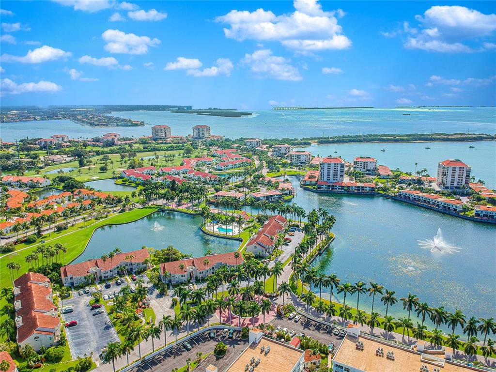 An aerial view of a waterfront residential complex with multiple buildings, pools, and palm trees — 5901 BAHIA DEL MAR CIRCLE UNIT 518, ST PETERSBURG, FL