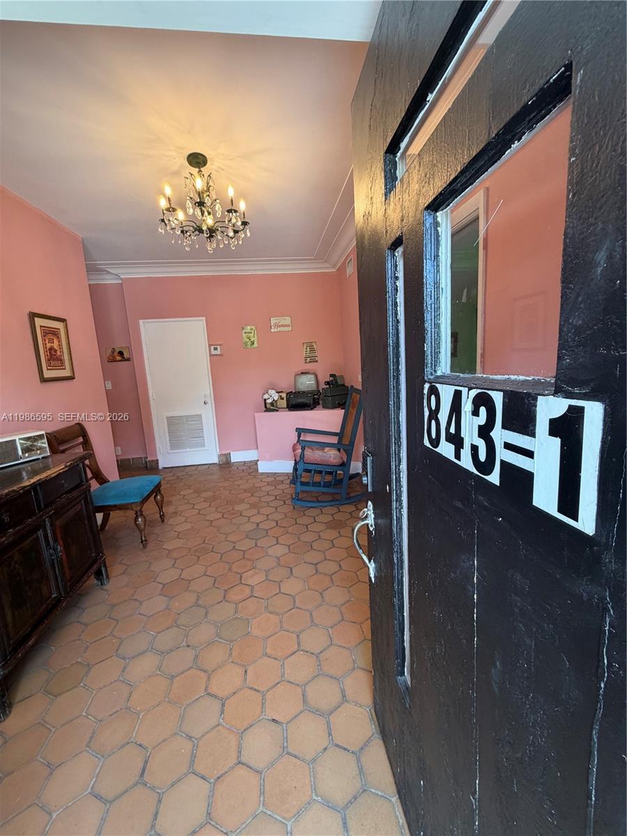 A view through an open door into a pink-walled room with hexagonal floor tiles — 843 NW 3rd St # 1, Miami FL 33128, MIAMI, FL