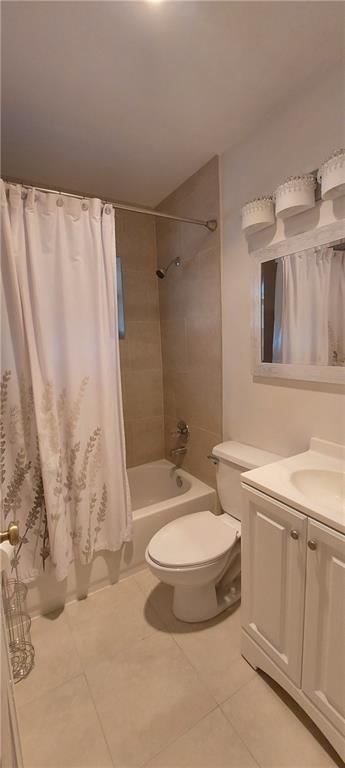 A bathroom with a white vanity, a toilet, and a shower-tub combination with beige tile — 738 SW 5th Avenue, Hallandale Beach FL 33009, HALLANDALE BEACH, FL