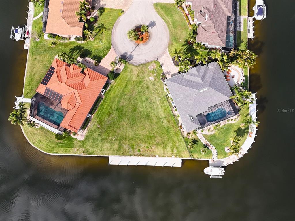 Aerial view of two waterfront houses with pools and a shared cul-de-sac — 402 VALLETTA COURT, PUNTA GORDA, FL
