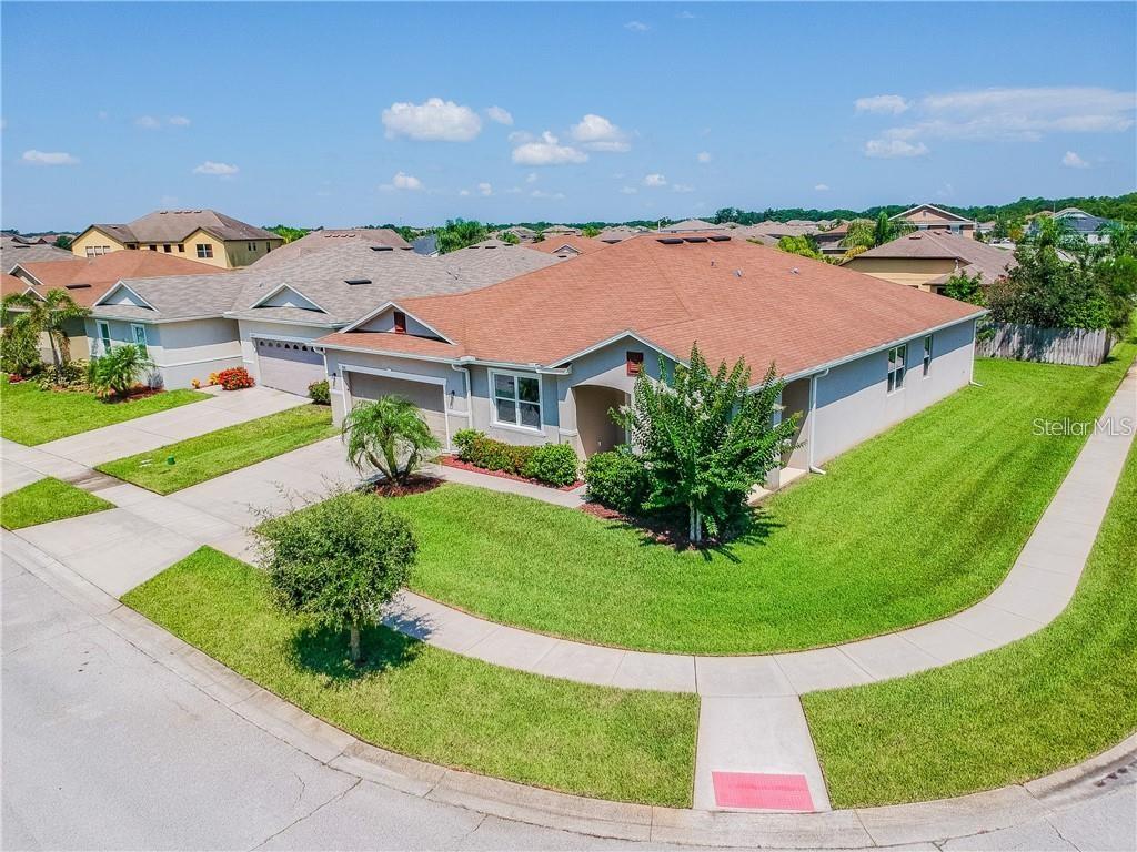 An aerial view of a suburban single-story house with a brown roof and lawn — 1501 ANGLER AVENUE, KISSIMMEE, FL