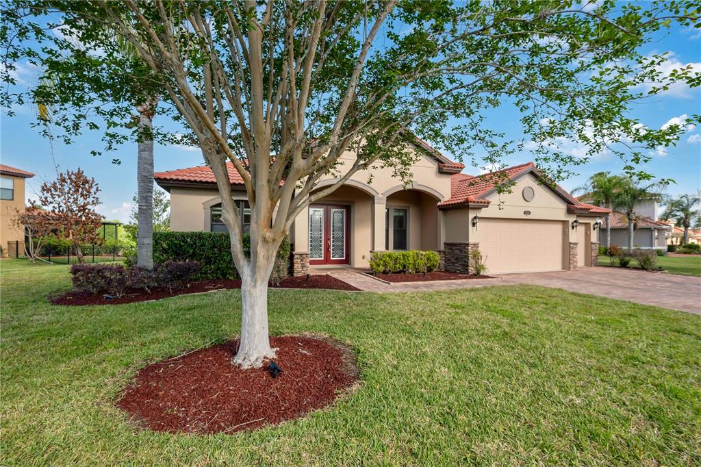 A kitchen with dark wood cabinets, black granite countertops, stainless steel appliances, and tile flooring — 3950 SUNSET LAKE DRIVE, LAKELAND, FL