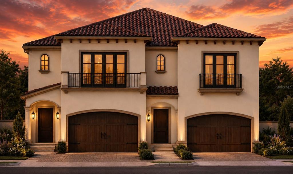 This is a rendering of a two-story Mediterranean-style duplex with two garages at sunset — 1968 FREEDOM DRIVE, CLEARWATER, FL