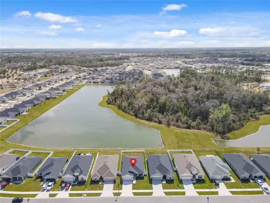 An aerial view shows a suburban neighborhood with a house marked by a red pin — 35598 BELLINGTON BOULEVARD, ZEPHYRHILLS, FL