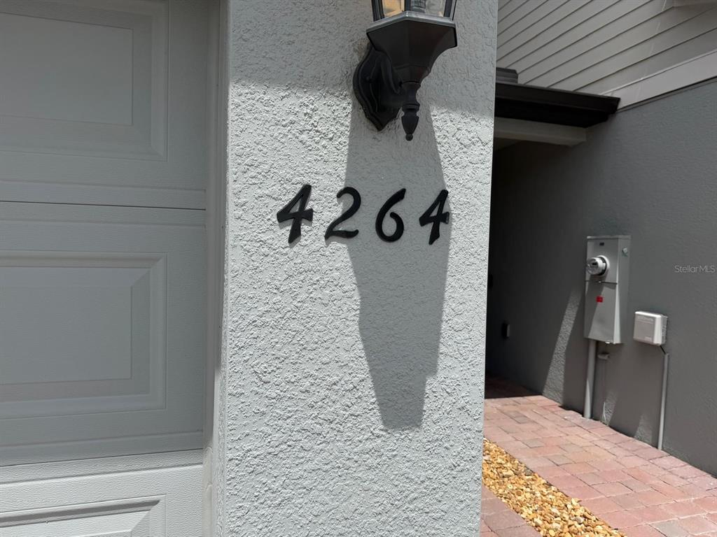 The house number 4264 is mounted on the exterior wall next to a garage door — 4264 RANCH HOUSE ROAD, ST CLOUD, FL
