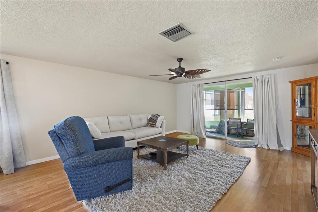 An interior hallway leads to a bathroom, a bedroom, and an open front door — 680 CIRCLEWOOD DRIVE UNIT W3, VENICE, FL