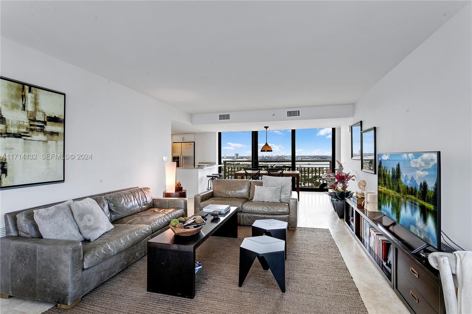 A living room features two leather sofas, a dark coffee table, and a balcony view — 3000 N Ocean Dr # 20A, Riviera Beach FL 33404, RIVIERA BEACH, FL