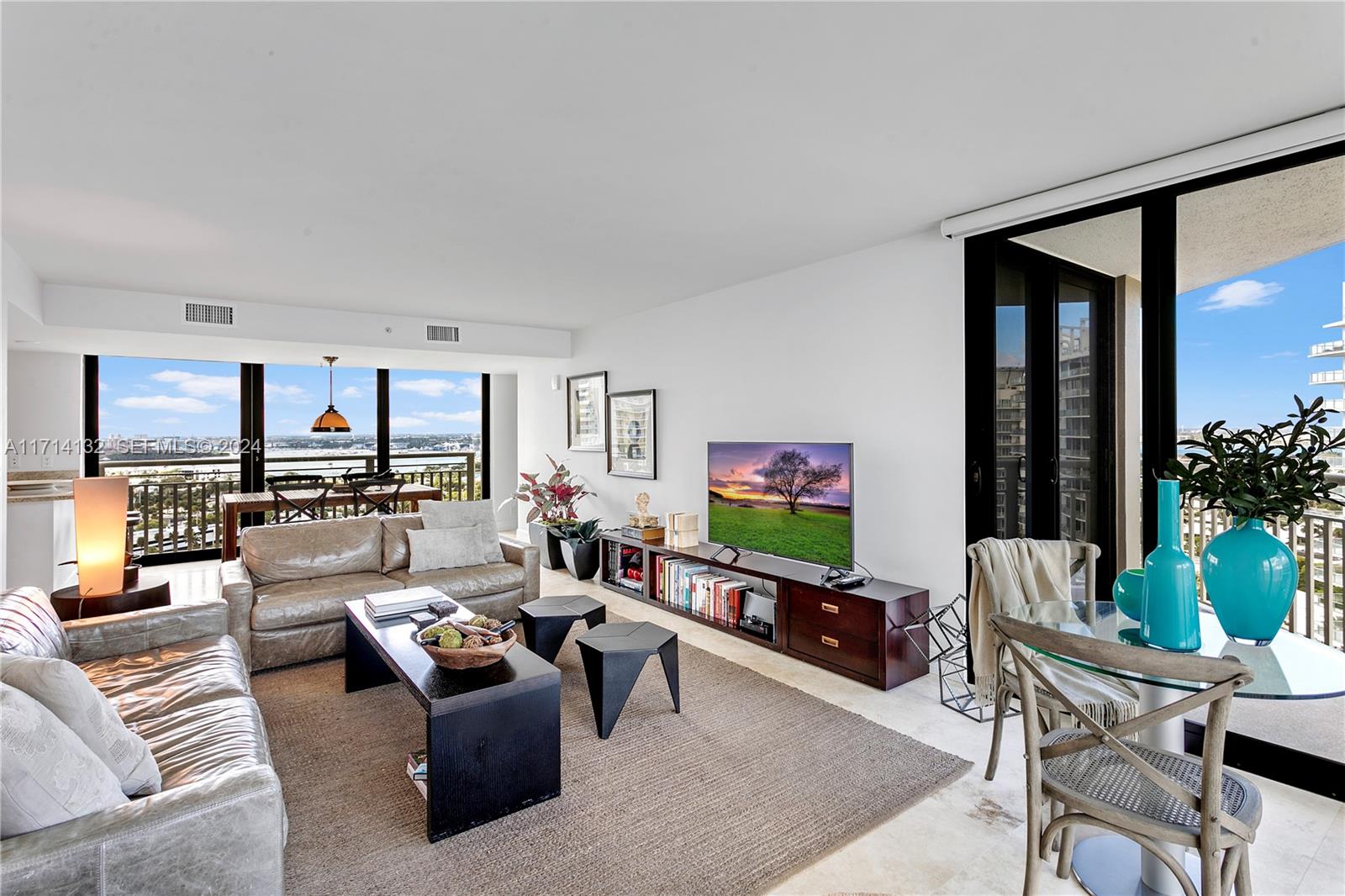 A living room features a leather sofa, a television console, and a glass dining table — 3000 N Ocean Dr # 20A, Riviera Beach FL 33404, RIVIERA BEACH, FL