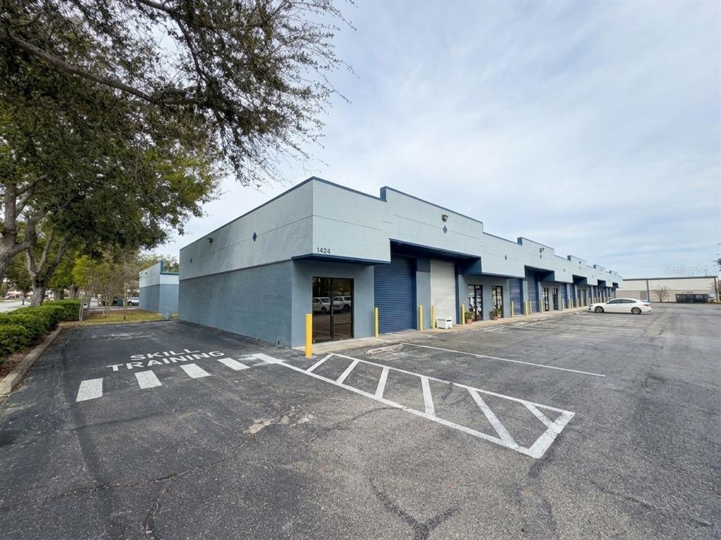 An indoor basketball court features a polished wood floor, purple painted sections, and mirrored walls — 2013 MURCOTT DRIVE UNIT 1,2,3, ST CLOUD, FL